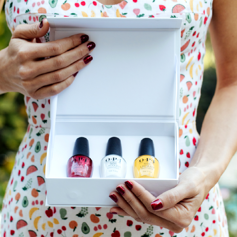 White open gift box with three OPI nail polishes